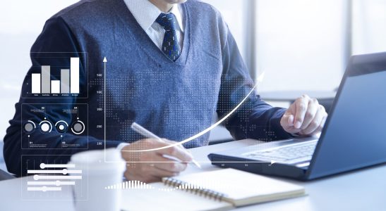 Businessman looking into a laptop computer notebook deeply reviewing financial reports for a return on investment or investment risk analysis.